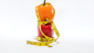 a measuring tape wrapped around a bell pepper